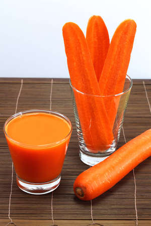 Carrot cut into slices and carrot juice の写真素材