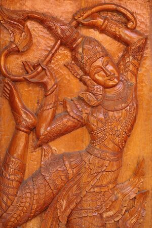 The carved angels on the doors of the temple in the Thai temple の写真素材