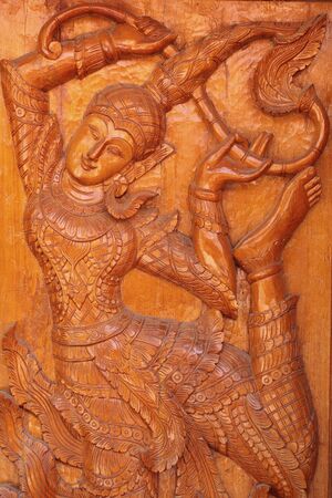 The carved angels on the doors of the temple in the Thai temple の写真素材