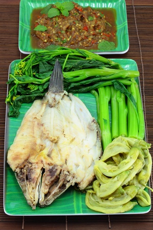 Thai cuisine name Steamed fish with boiled vegetables and sauce の写真素材