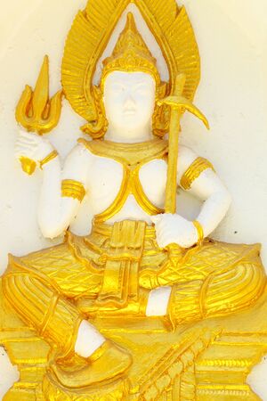 Armed goddess statue on the wall of the pagoda of Wat Thai の写真素材