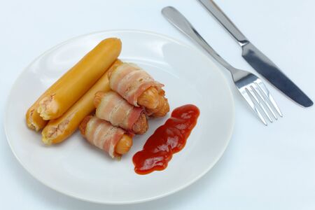 Sausage on a plate and sauce の写真素材