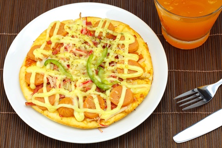 Fancy pizza sausage and beverages の写真素材