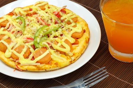 Fancy pizza sausage and beverages の写真素材