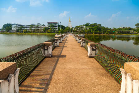 The bridge across the lake in a park Wat Phra That Nong Bua in Ubon Ratchathani, Thailand の写真素材