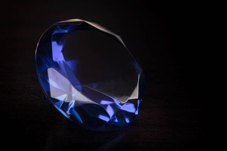 Close-up blue diamond on a black background 
