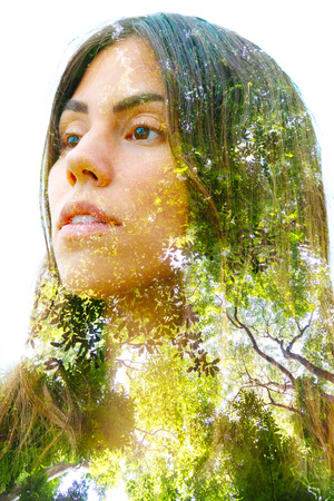 Double exposure close up portrait combined with bright green leaves of large trees