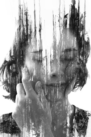 Paintography. Double exposure. Young girl with short hair disappears behind hand made ink painting...