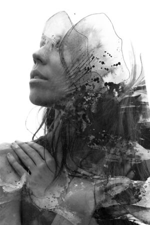 Paintography. Double exposure of woman's profile dissolving into hand drawn ink painting with petal motif, black and whiteの写真素材