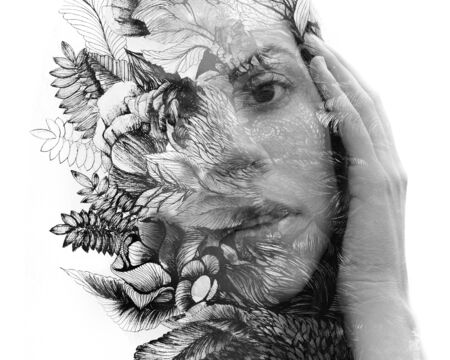 Paintography. Double exposure of woman's portrait dissolving into hand drawn leaves, black and white