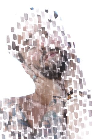 Paintography. Double exposure close up portrait of a serious male model disappearing behind a curtain of handmade ink brushstrokes which resemble large particlesの写真素材
