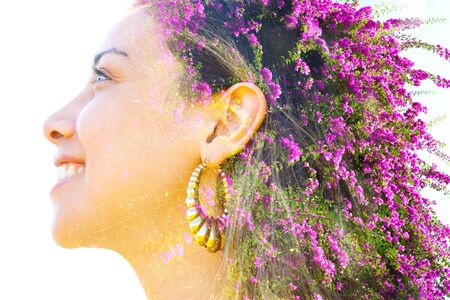 Double exposure profile portrait of a young, smiling natural beauty combined with beautiful purple Bougainvillea flowersの写真素材