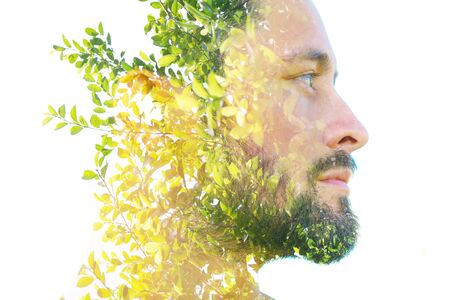 Double exposure close up profile portrait of an attractive man combined with plants, created with an...