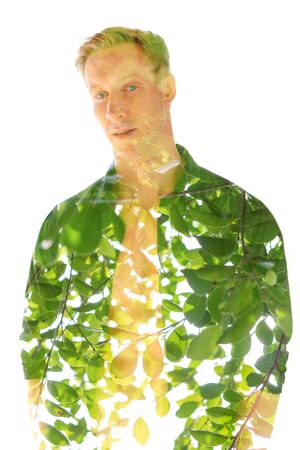 Double exposure portrait of an attractive blonde man combined with plants, created with an ecological conceptの写真素材
