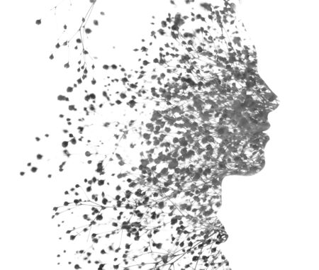 Double exposure of a young handsome mans profile portrait blended with lush leaves