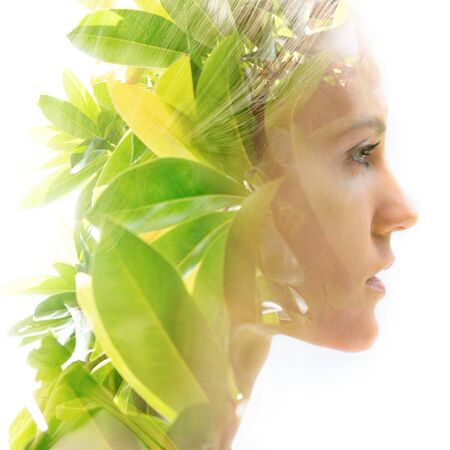 Double exposure portrait of a woman combined with a photograph of nature
