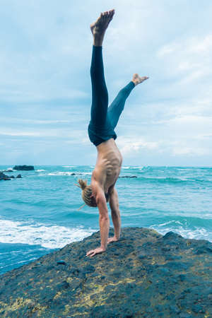 Athlete man practicing on a rock