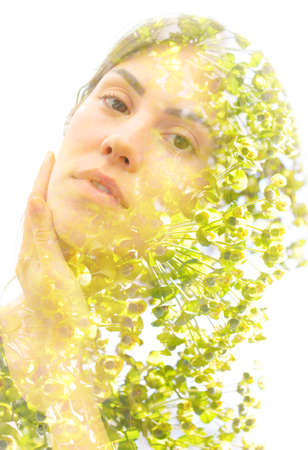 Young woman double exposure portrait with leavesの写真素材