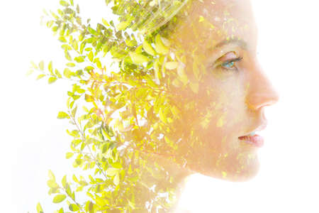 Double exposure of a beautiful womans profile on white background