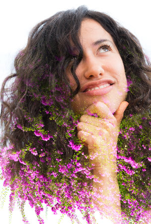 A colorful double exposure portrait of a half smiling thoughtful young woman with curly hair holding...