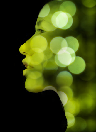 A double exposure portrait of a young womans profile against black backgroundの写真素材