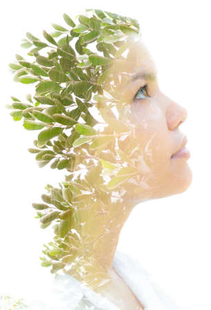 A portrait of a womans profile combined with ree double exposureの写真素材