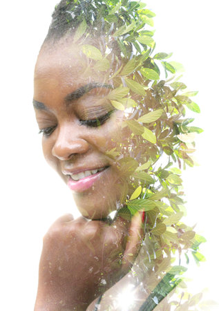 Merging with nature. Double exposure portrait of an African American woman