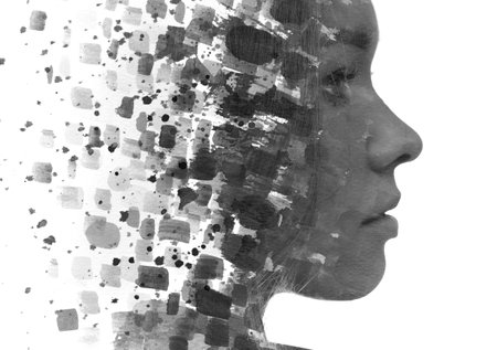 A black and white profile portrait of a young woman dissolving into various ink shapes. Paintography.の写真素材