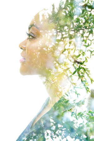 A profile portrait of an attractive woman combined with foliage. Double exposure.