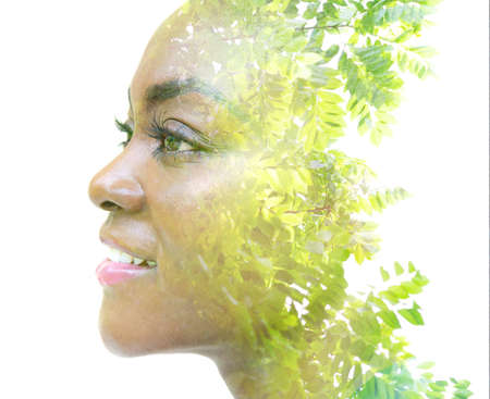 A portrait of an attractive girl combined with foliage. Double exposure.の写真素材