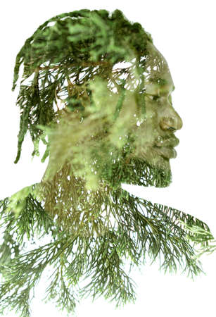 A portrait of a man combined with green twigs in a double exposure technique.