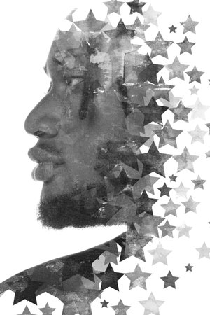 A double exposure portrait of an African American man combined with digital art.の写真素材