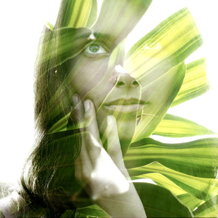 A portrait of a beautiful woman combined with tropical plantsの写真素材