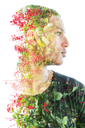 Double exposure portrait of a young man combined with vibrant flowers