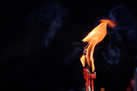 The flame of the candle is burningの写真素材