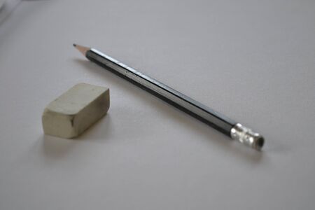 Pencil and eraser on the drawing paper の写真素材