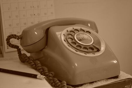 The phone is placed next to a notebook の写真素材