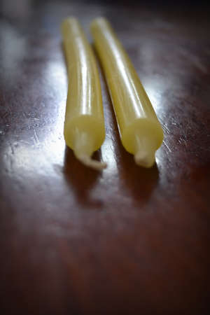 Yellow candle on the wooden table.の写真素材