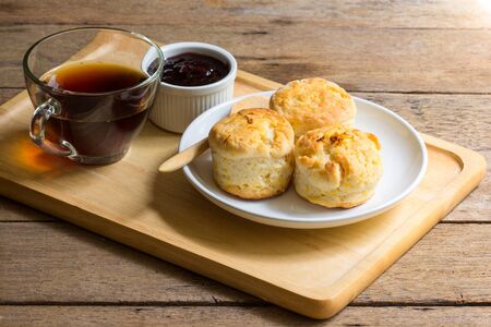 Home made orange English biscuit with blackberry jam and black coffee.の写真素材