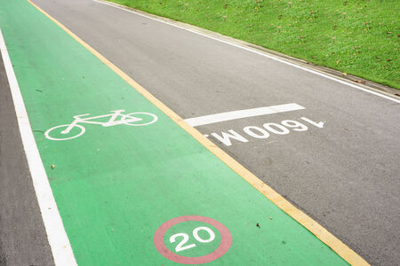 a green bicycle lane  in a parkの写真素材