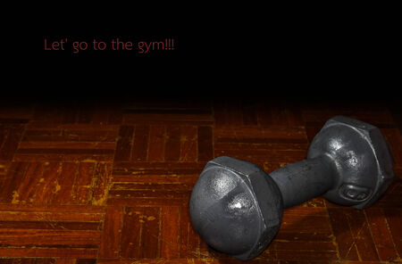 a dumbbell is on the wooden floorの写真素材