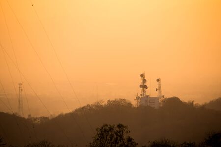 siluate network attenna with orange skyの写真素材