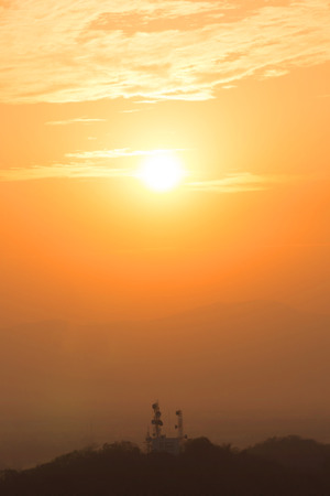 siluate network attenna with orange skyの写真素材