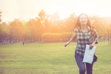 an happyness asian woman is running in a park in vintage colorの写真素材