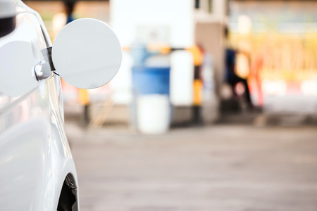 a white car open the fuel cap in the gas stationの写真素材