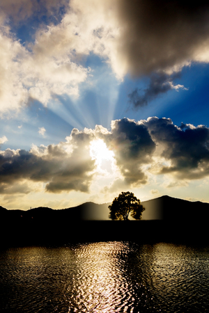 sunset with mountain tree and sea during summer in thailandの写真素材