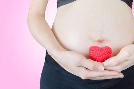 pregnancy lady is holding heartの写真素材