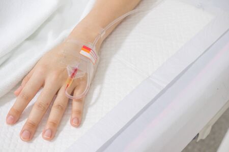 hand taking saline with bloodの写真素材