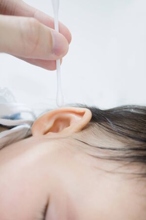 ear cleaning brush with baby's ear represent to cleaning baby's earの写真素材