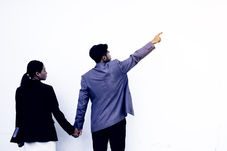 Business man with pointing to something on white background